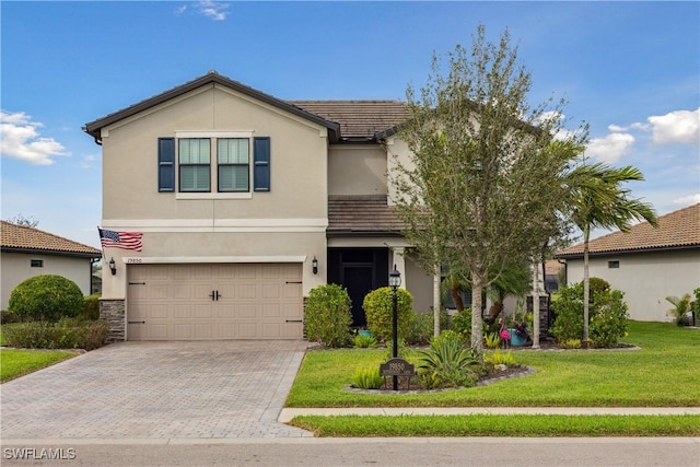 view of front of house with a garage and a front lawn