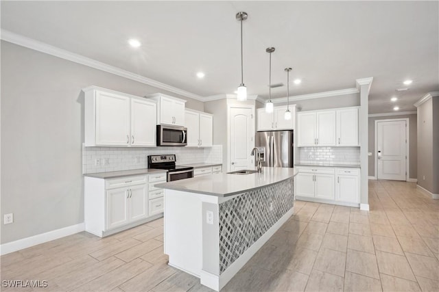 kitchen with appliances with stainless steel finishes, pendant lighting, white cabinetry, and sink