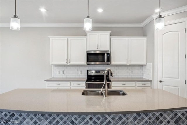 kitchen featuring white cabinetry, sink, hanging light fixtures, and stainless steel appliances