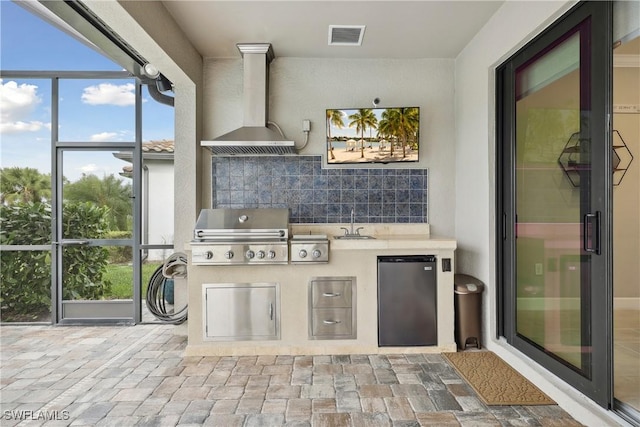 view of patio featuring a grill, area for grilling, and sink