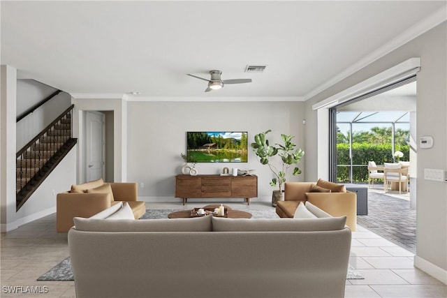 tiled living room with ceiling fan and crown molding