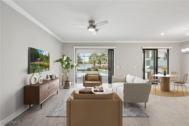 living room with ceiling fan and ornamental molding