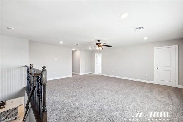 empty room featuring ceiling fan and carpet