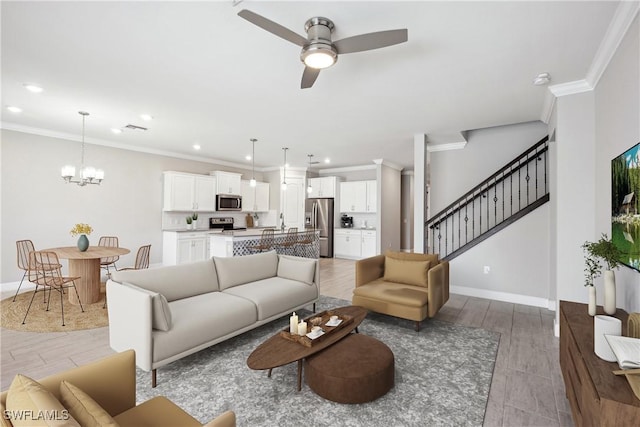 living room featuring ornamental molding, ceiling fan with notable chandelier, and light hardwood / wood-style flooring