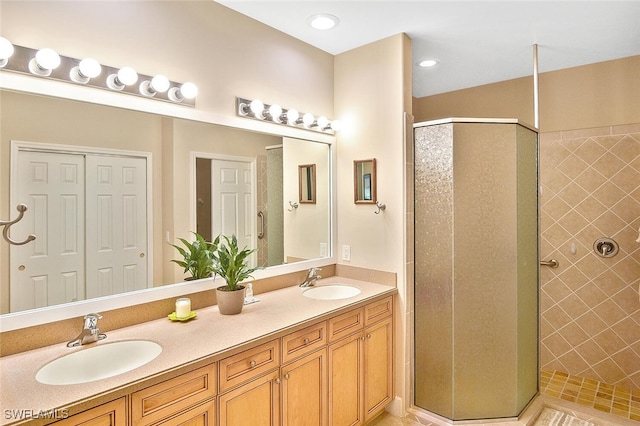 bathroom featuring tiled shower and vanity