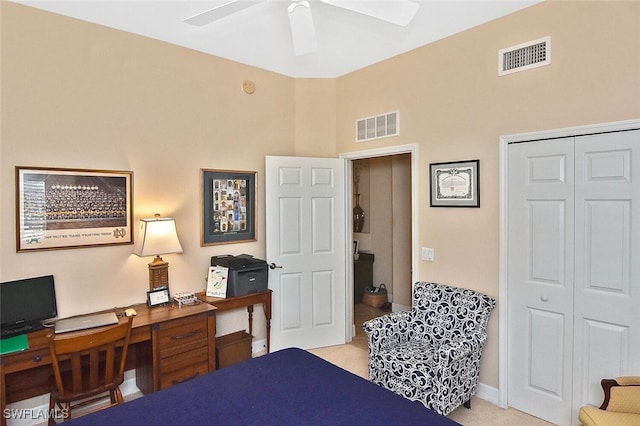 bedroom featuring light carpet, ceiling fan, and a closet