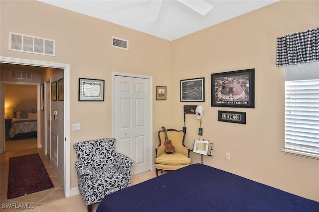 bedroom featuring light tile patterned floors, a ceiling fan, and visible vents