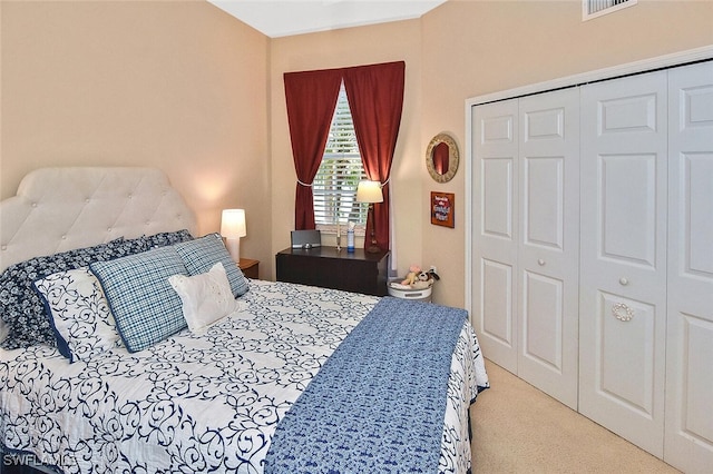 bedroom with visible vents, a closet, and carpet floors