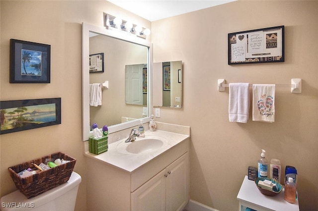 bathroom with vanity and toilet