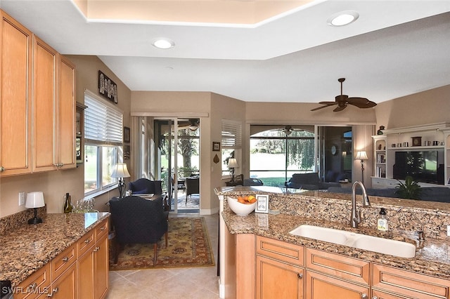 kitchen with light tile patterned flooring, plenty of natural light, sink, and ceiling fan