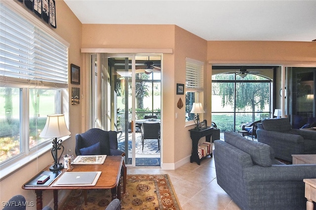 living room with ceiling fan and light tile patterned floors