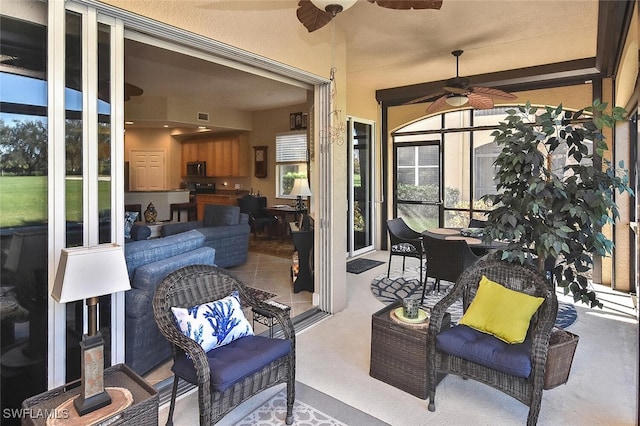 sunroom / solarium featuring ceiling fan