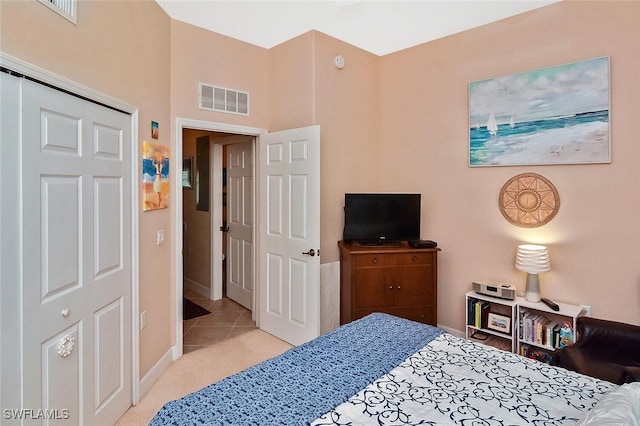 bedroom featuring visible vents, tile patterned floors, carpet, and baseboards