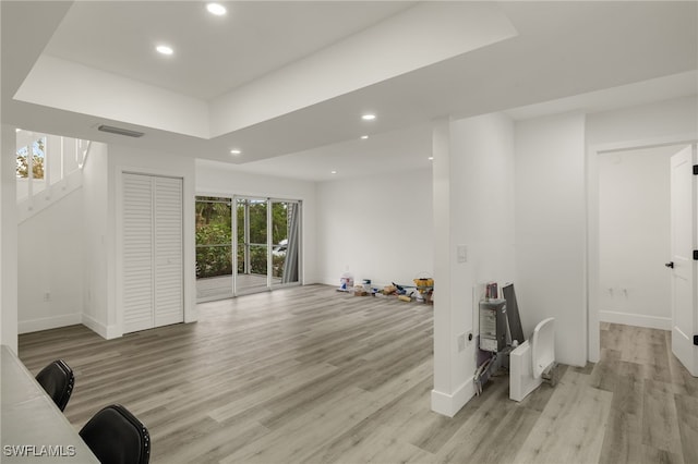 exercise room with light wood-type flooring