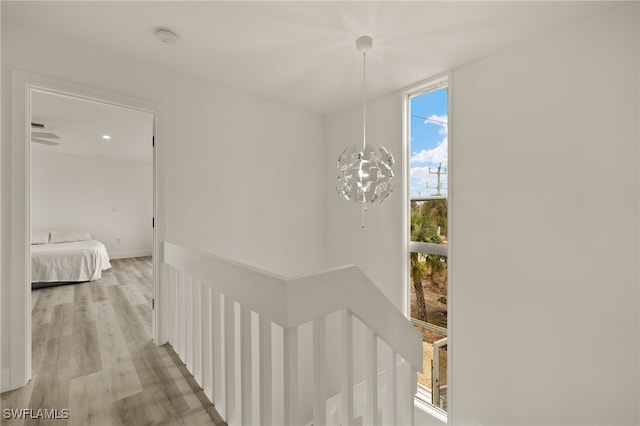 hall featuring a chandelier and light wood-type flooring