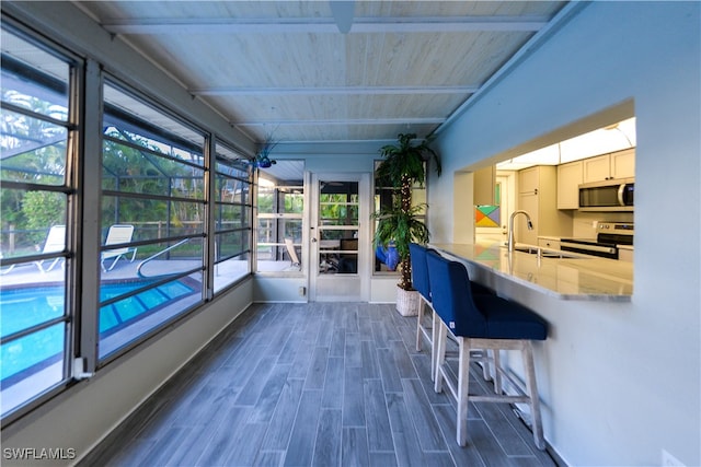 sunroom / solarium with a wealth of natural light and sink