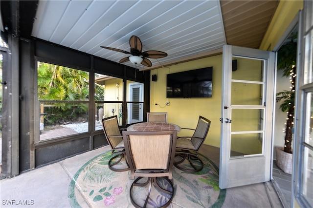 sunroom / solarium with ceiling fan and wooden ceiling