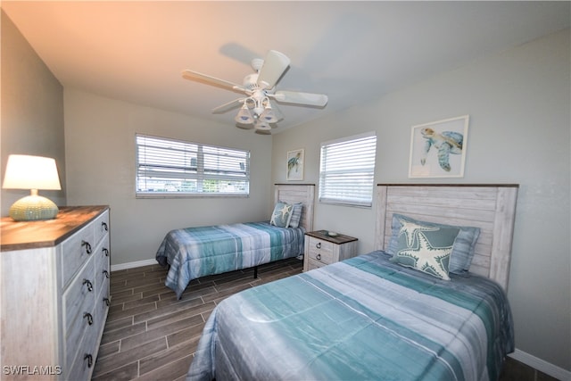 bedroom with dark hardwood / wood-style floors and ceiling fan