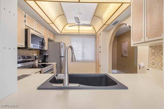 kitchen featuring appliances with stainless steel finishes, sink, and decorative backsplash