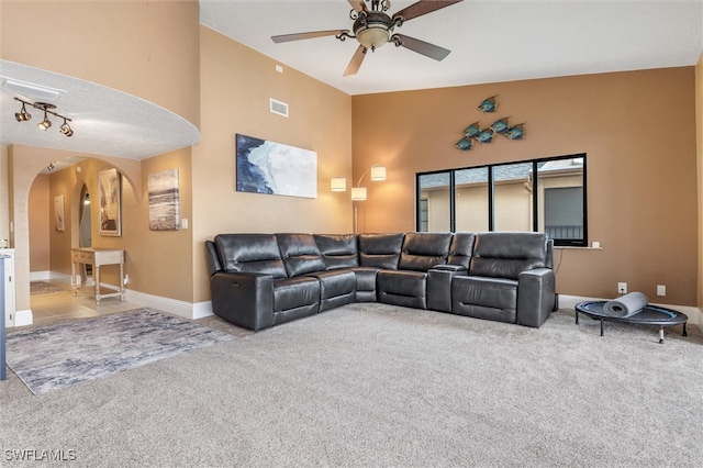 carpeted living room with ceiling fan