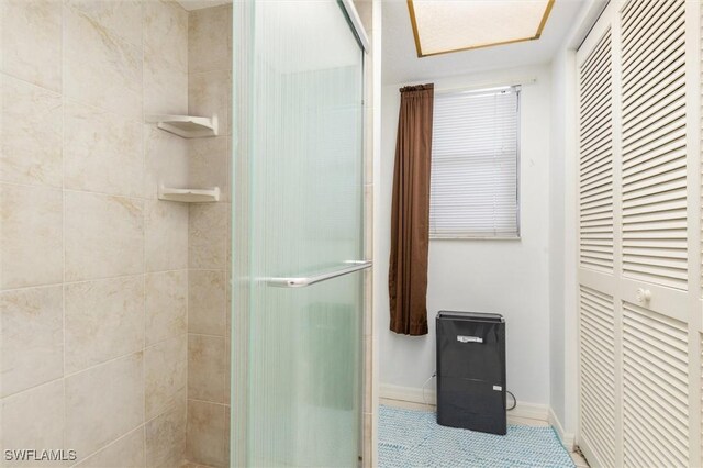 bathroom featuring tile patterned flooring and a shower with door