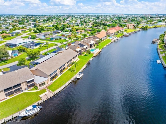 drone / aerial view featuring a residential view and a water view