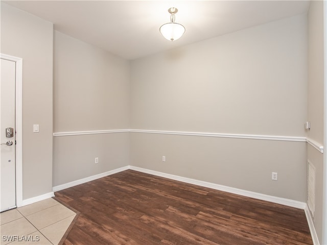 empty room with hardwood / wood-style floors