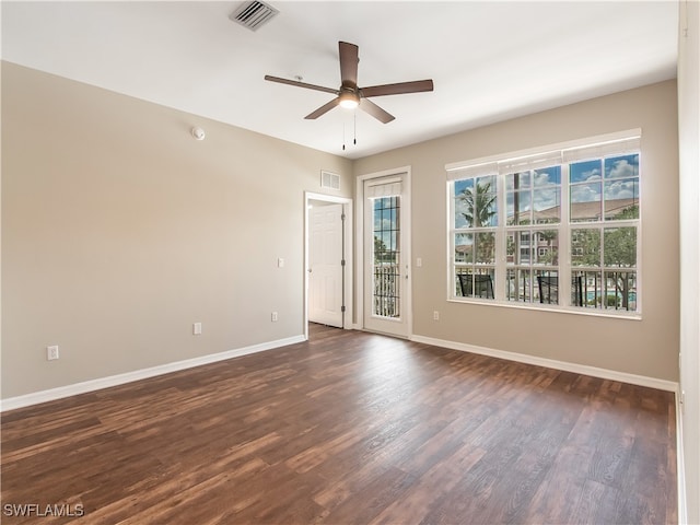 spare room with ceiling fan and dark wood-type flooring