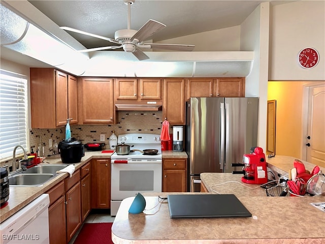 kitchen featuring vaulted ceiling, decorative backsplash, sink, ceiling fan, and white appliances