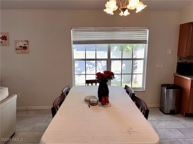 tiled dining space with an inviting chandelier