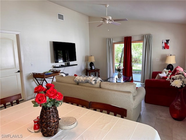 tiled living room featuring ceiling fan and vaulted ceiling