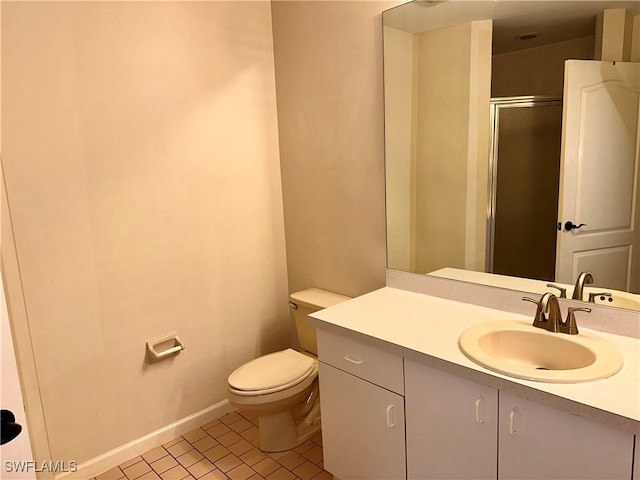 bathroom with toilet, vanity, tile patterned floors, and walk in shower