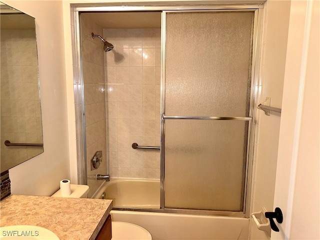 full bathroom with toilet, combined bath / shower with glass door, and vanity