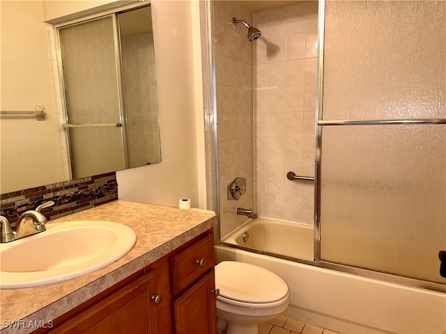 full bathroom with toilet, tile patterned flooring, shower / bath combination with glass door, vanity, and backsplash