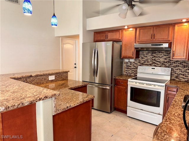 kitchen with light stone counters, hanging light fixtures, ceiling fan, stainless steel refrigerator, and white electric range