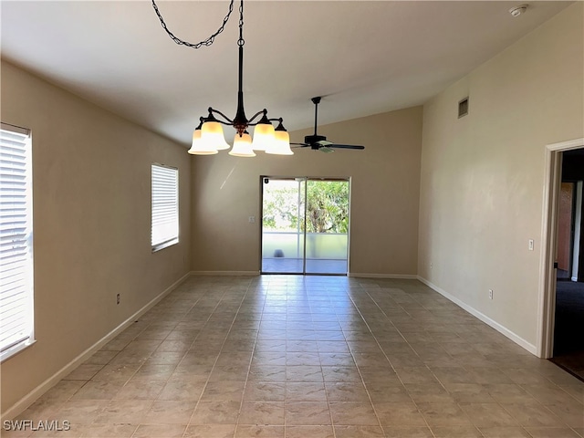 tiled spare room with ceiling fan with notable chandelier and vaulted ceiling