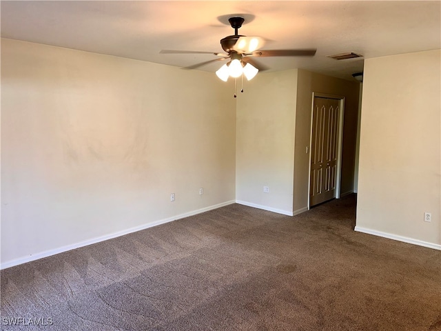 empty room featuring ceiling fan and dark colored carpet