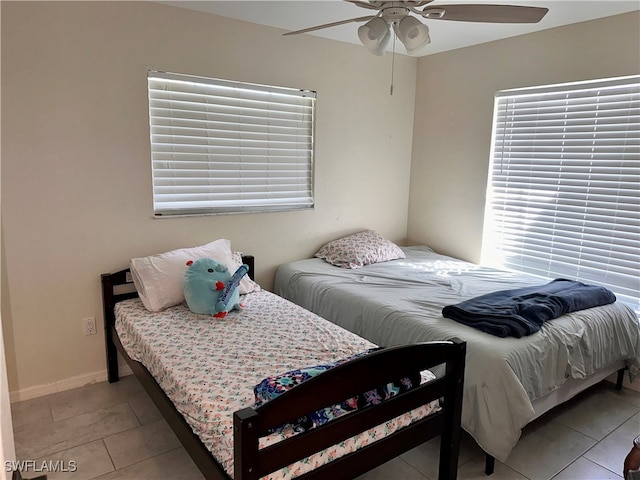 tiled bedroom featuring ceiling fan