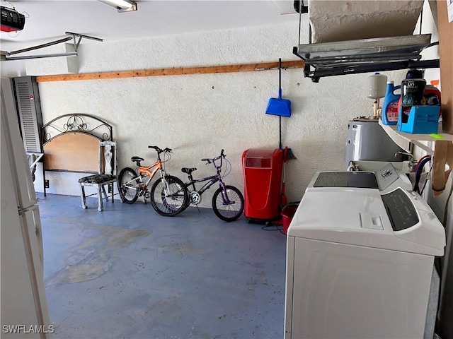 garage with washer and dryer, white refrigerator, and a garage door opener