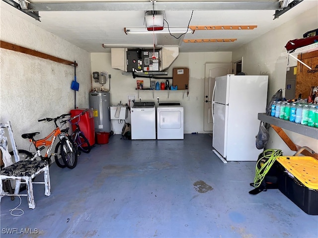 garage featuring white fridge, sink, washing machine and clothes dryer, a garage door opener, and electric water heater