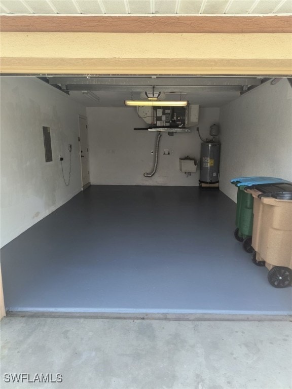 garage featuring water heater and electric panel