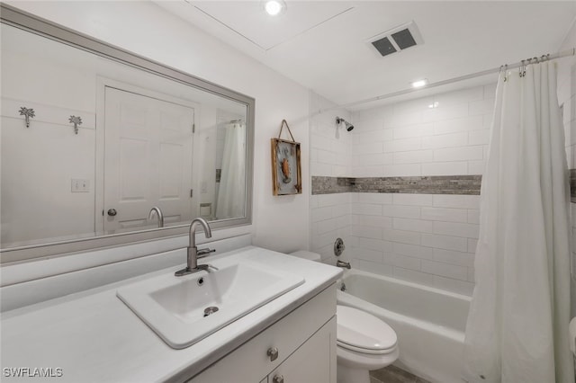 full bathroom with vanity, shower / bath combo with shower curtain, and toilet