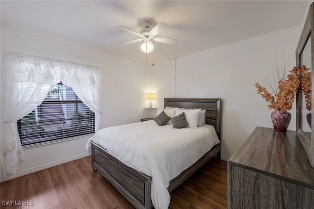 bedroom with ceiling fan and dark hardwood / wood-style floors