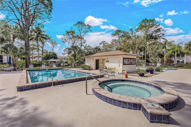 view of pool with a patio and a community hot tub