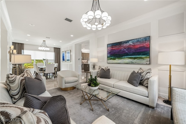 living room with ornamental molding and a notable chandelier