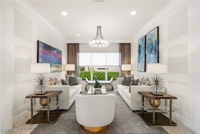 living room with an inviting chandelier and ornamental molding