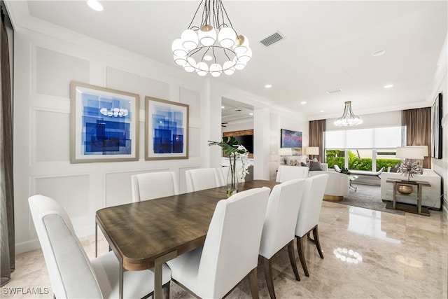 dining area with crown molding and a chandelier