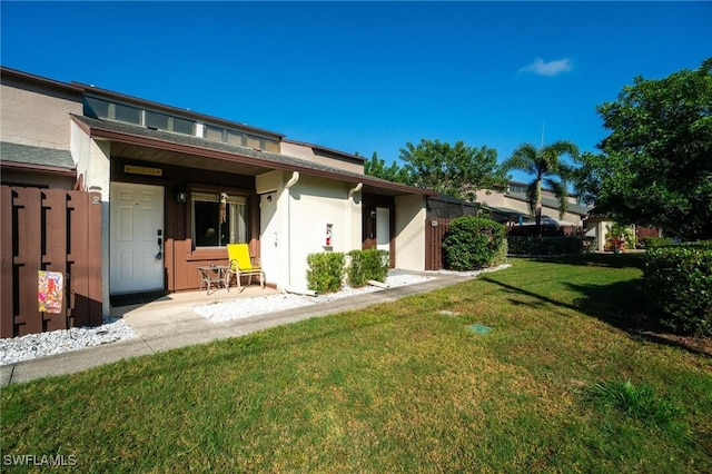 8913 Somerset Blvd, Fort Myers, FL 33919 - back of house with stucco siding, fence, and a yard
