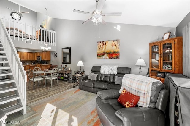 8913 Somerset Blvd, Fort Myers, FL 33919 - living room with high vaulted ceiling, a ceiling fan, stairs, and light wood-style floors