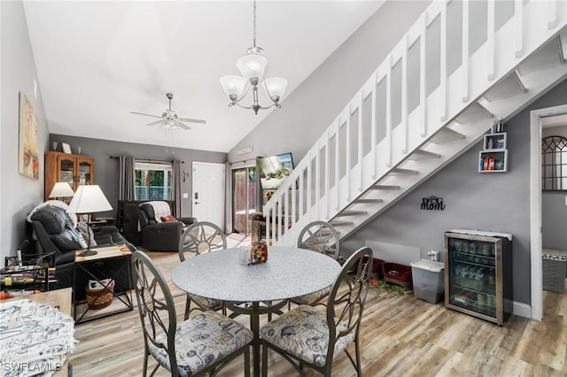 8913 Somerset Blvd, Fort Myers, FL 33919 - dining room featuring lofted ceiling, wine cooler, wood finished floors, and stairway